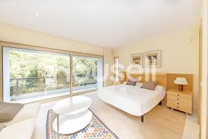 a bedroom with a bed and a large window at Villa Tarifa in Tarifa