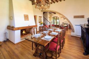 a dining room with a long table and a fireplace at Il Fienile di Montesoli in Villa Montesoli