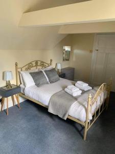 a bedroom with a large bed with two towels on it at The Gables in Hunstanton