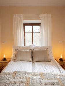 
a bed with a white comforter and pillows at Martinkovice 201 Broumov in Martínkovice
