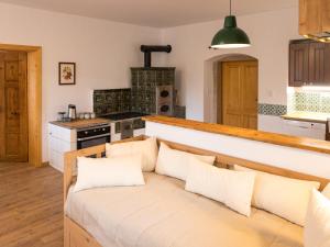 a kitchen with a bench with pillows on it at Martinkovice 201 Broumov in Martínkovice +67 photos