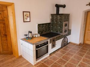 
a kitchen with a stove top oven and a microwave at Martinkovice 201 Broumov in Martínkovice
