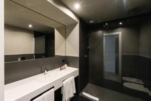 a bathroom with a sink and a mirror at Hotel Punta Tipa in Trapani