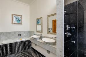 a bathroom with two sinks and a shower at Lainston House in Winchester