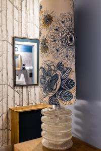 a vase sitting on a table in front of a mirror at Brilliant Apartments in Berlin