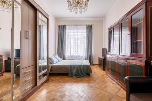 a bedroom with a bed and a large window at Апартаменты у Невского проспекта in Saint Petersburg