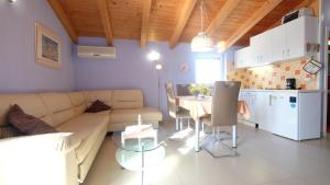 a living room with a couch and a table and a kitchen at Apartments Beti in Poreč
