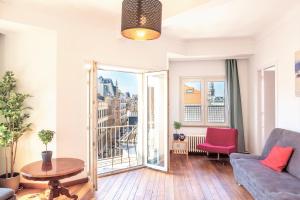 a living room with a couch and a table at Penth A Apartment in Heart of Antwerp in Antwerp