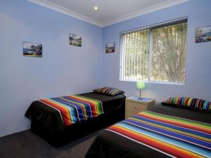 a bedroom with two beds and a window at Anchorage 7 in Tuncurry