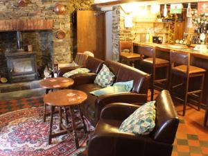 a living room with couches and a bar at Afon Duad Inn and Dolau Cottage in Cwm-Duad