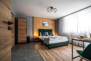 Posteľ alebo postele v izbe v ubytovaní Apartamenty Tatrzańskie Doliny