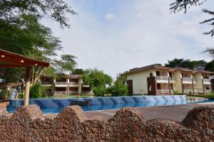 an image of a swimming pool at a resort at Hunters Lodge in Twaandu