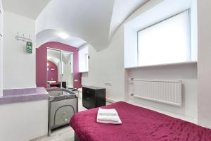 a bedroom with a purple bed and a sink at Guest House Prosto in Saint Petersburg