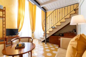 a living room with a table and a staircase at Locanda Il Maestrale in Monterosso al Mare