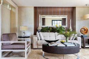 a living room with a couch and a table at Red Level at Gran Melia Palacio de Isora - Adults Only in Alcalá