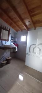 a bathroom with a sink and a toilet in a room at Casa da Bisa - Santa Maria - Açores in Santa Bárbara