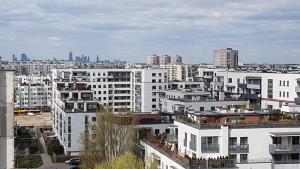 a view of a city with white buildings at Niebieski Meander Pokoje blisko metra in Warsaw