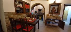 a kitchen with a table and chairs and a kitchen with a counter at Casa da Bisa - Santa Maria - Açores in Santa Bárbara +14 photos