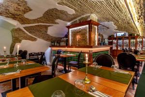 a restaurant with wooden tables and chairs in a room at CASA JOSEPH HAYDN in Sighişoara