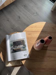 a magazine sitting on a table next to a vase at Hypnos Boutique Hotel in Nicosia