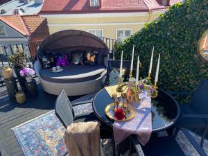a patio with a bed and tables with candles on it at Rataskaevu Boutique - 7 Unique Apartments in Tallinn