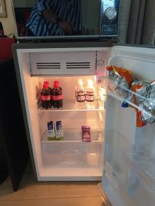 an open refrigerator with food and drinks in it at Christa's Place 897 in Pretoria