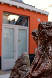 a statue of a bear in front of a building at Canalview Hotel Ter Reien in Bruges
