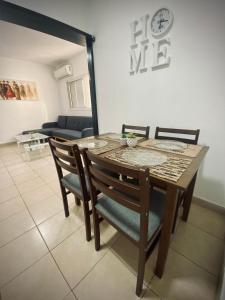 a wooden table and chairs in a living room at Dream On The Sea Of Galilee in Tiberias