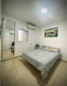 a bedroom with a bed and a large mirror at Dream On The Sea Of Galilee in Tiberias