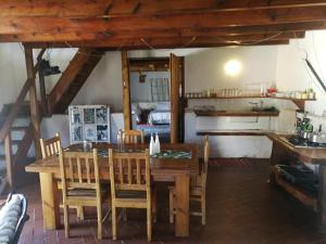 a dining room with a wooden table and chairs at Klipfontein Rustic Farm & Camping in Tulbagh
