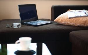 a laptop computer sitting on top of a couch at The Palm Garden Hotel in Chiang Rai