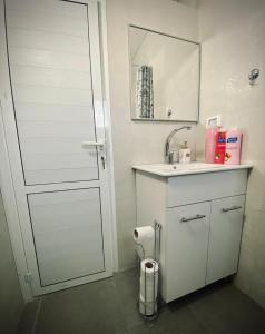 a white bathroom with a sink and a mirror at Dream On The Sea Of Galilee in Tiberias