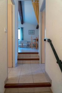 a hallway leading to a room with a dining room at Gîte Mairie in Fosse
