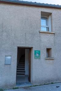 a building with a stairway leading to a door at Gîte Mairie in Fosse +1 photo