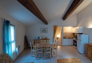 a kitchen and dining room with a table and chairs at Gîte Mairie in Fosse