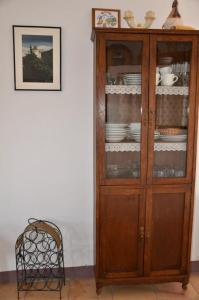 a wooden cabinet with plates and dishes in it at RCP El Racó in Pacs del Penedes