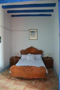 a bedroom with a bed with a blue ceiling at RCP El Racó in Pacs del Penedes