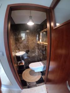 a bathroom with a toilet and a sink at Apartament Magdaleentje in Gdańsk