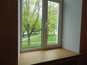 an open window with a view of a park at Gogol Park Rooms in Rīga