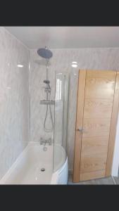 a bathroom with a shower and a tub and a toilet at The Bay Horse Accommodation in Carlton