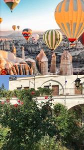 a group of hot air balloons flying over a building at Kemal's Guest House in Göreme