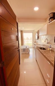 a kitchen with a sink and a counter top at Flat Mar Bello Plaza in Cabedelo