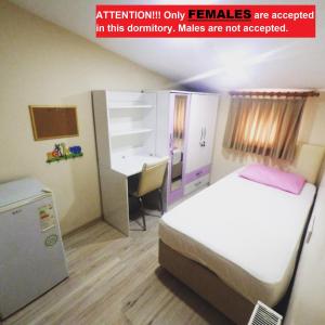 a room with a bed and a desk in it at !FEMALES ONLY! Bakırköy Elit Kiz Yurdu in Istanbul