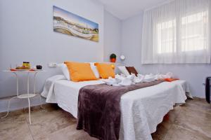 a bedroom with two beds with white and orange pillows at Barcelona City Seven in Barcelona
