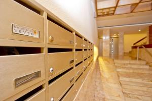 a long hallway with lockers in a building at Barcelona City Seven Hostal in Barcelona