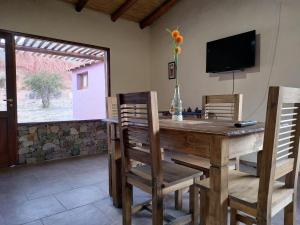 a dining room with a wooden table and chairs at Pirca del Abuelo II in Purmamarca