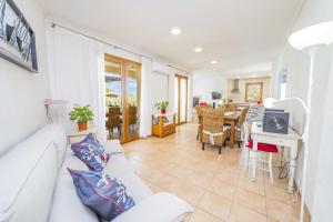 a living room with a white couch and a table at E227 Sa Pedrera by Mallorca Villa Selection in Caʼs Concos