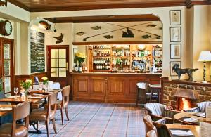 a restaurant with tables and chairs and a bar at The Sportsman's Arms in Harrogate