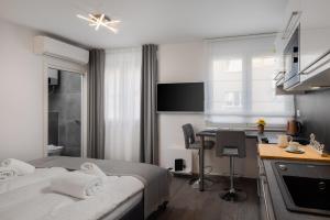 a bedroom with a bed and a desk and a kitchen at Luxury Studios & Room Five in Split