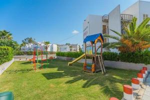 a playground with a slide in a yard at Villa Northern Star in Alcudia